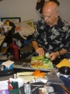 Image of Dick DeBartolo in his MAD office signing Mad magazines